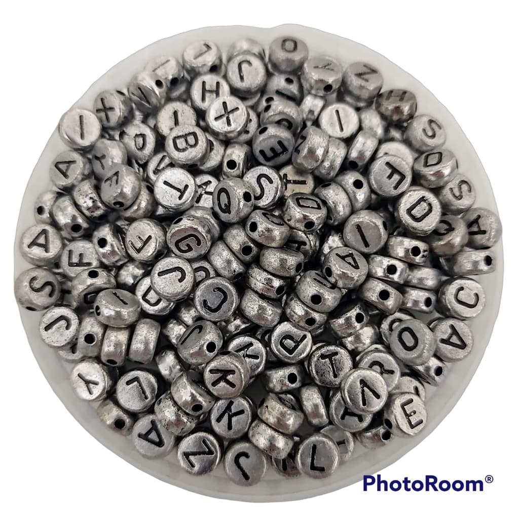 Entremeio redondo prata com letras pretas 4x7 mm  - Aprox. 200 Unidades