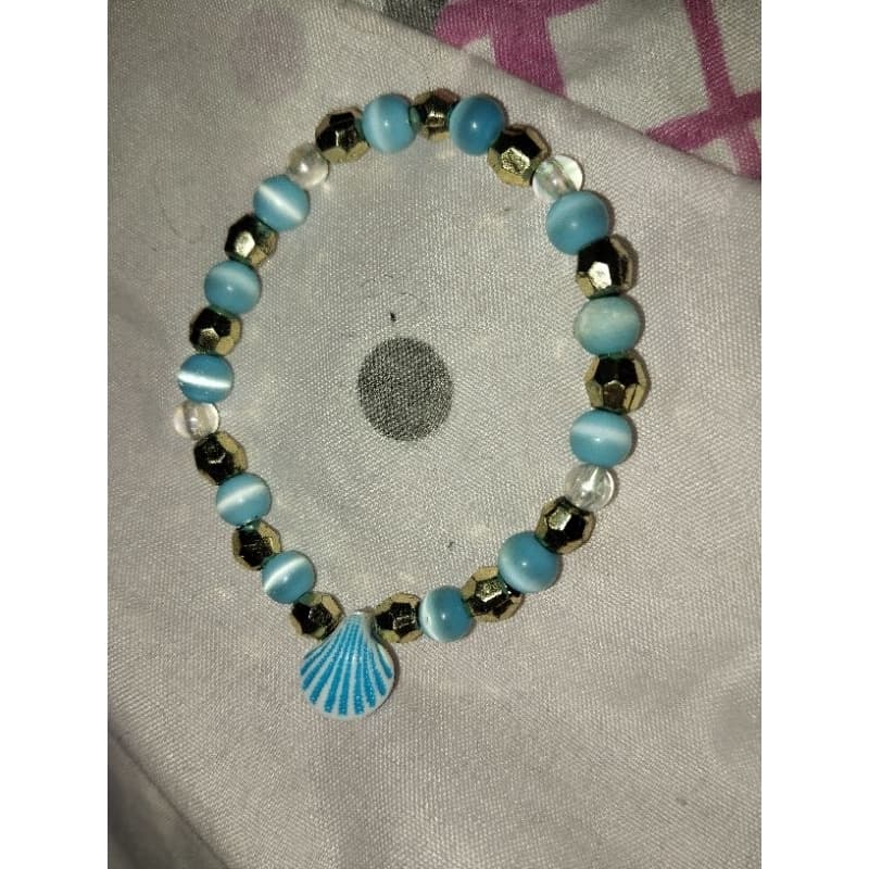 pulseira azul com dourado, Iemanjá, conchas, mar, umbanda, candomblé