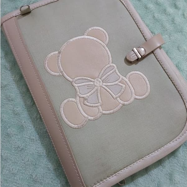 Porta documentos do bebê em material sintético verde e bege,  tema ursinho.