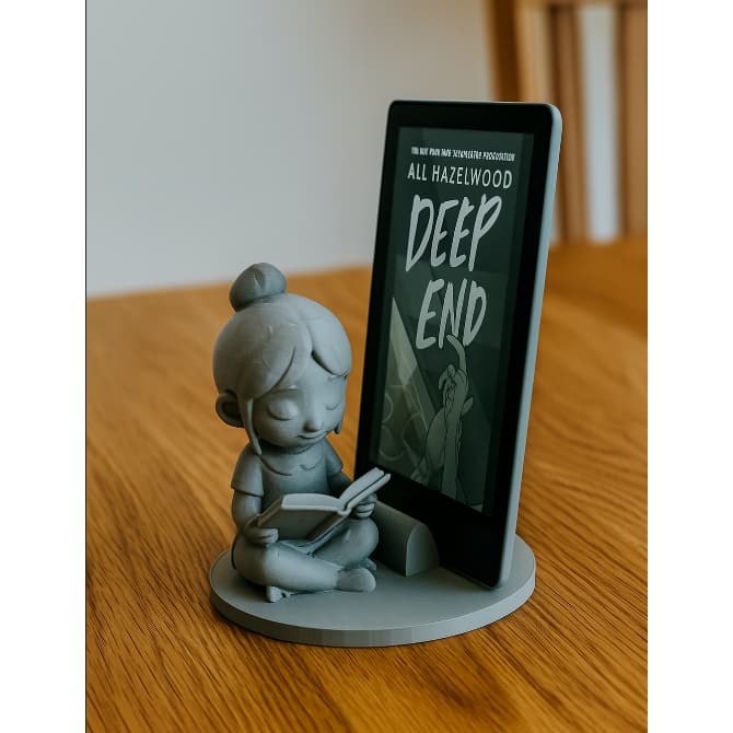 Suporte para Kindle ou tablet com personagem lendo – encantador, ideal para leitores e decoração