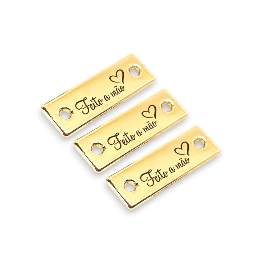 Etiqueta de Metal 2,4x0,8 cm Pronta Entrega – Frase "Feito a mão" 10 Unidades