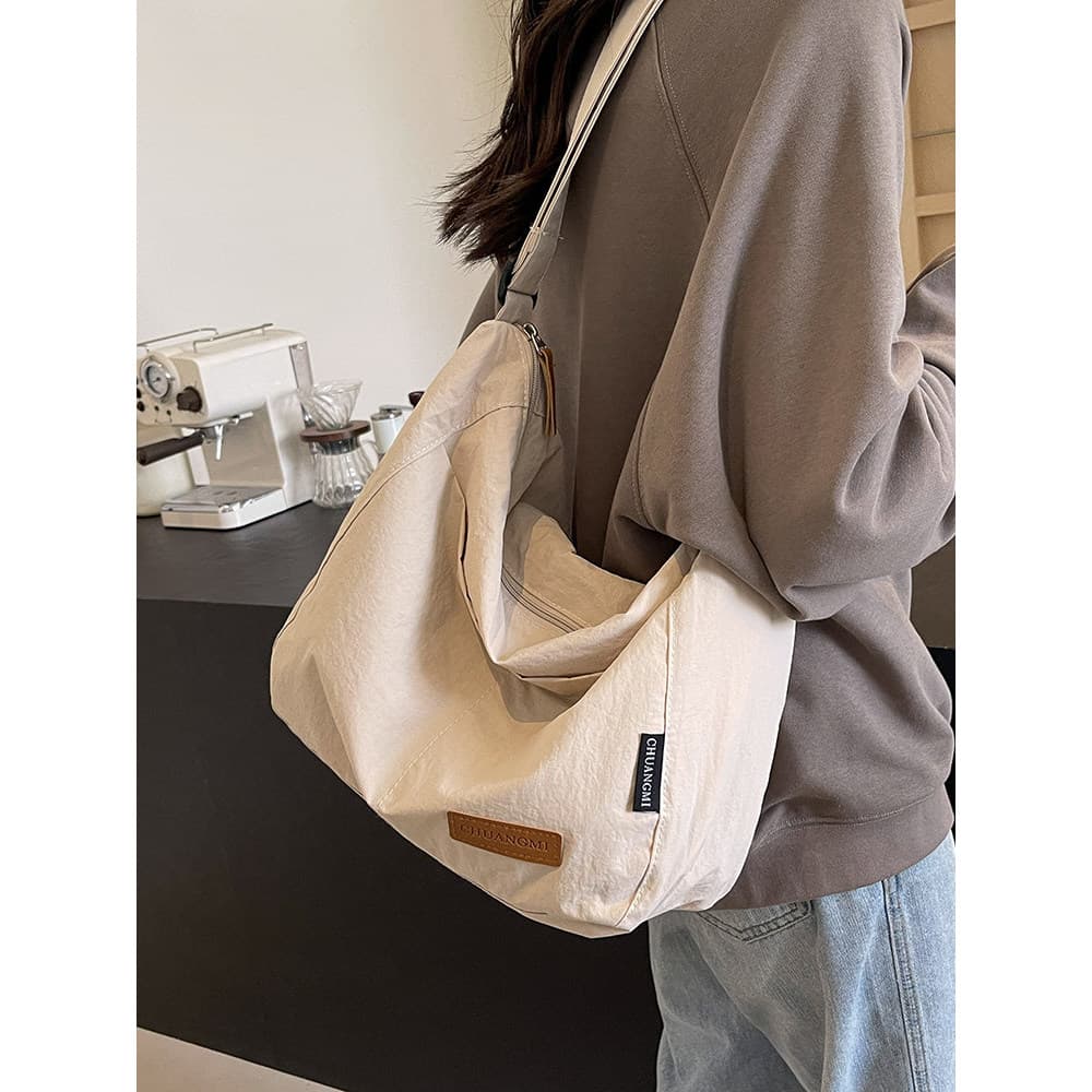 Bolsa de grande capacidade feminina outono inverno 2026 novo estilo lona ombro mensageiro Commuter saco Casual All-Match
