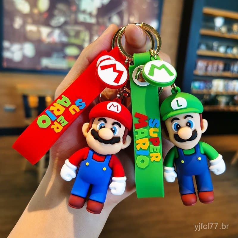 43 chaveiros, incluindo personagens como Luigi, Mario, Gorila, Princesa Dinossauro, Yoshi e outros, juntamente com adere