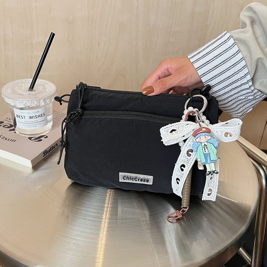 Nicho Design outono novo estilo náilon pequeno saco 2025 feminino Commuter Multi-camada High-End saco do mensageiro de v
