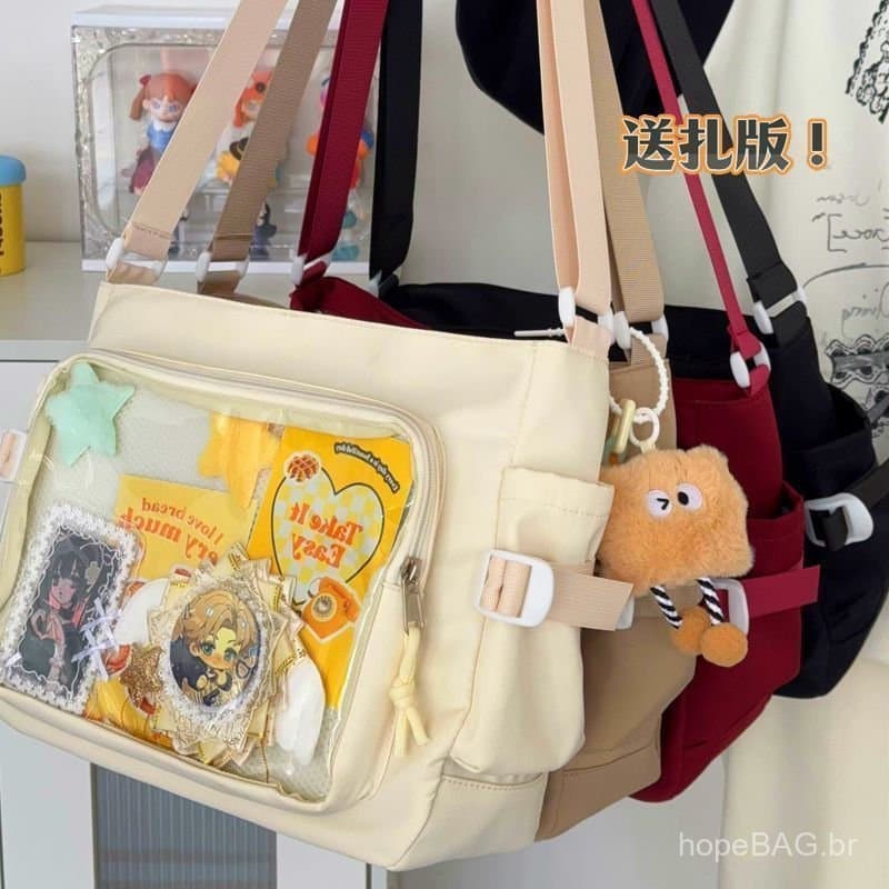 Ita Bag é uma bolsa mensageiro versátil, simples e de grande capacidade para uso escolar, uma bolsa de ombro transparent