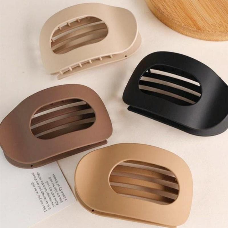 Um conjunto de presilhas de cabelo de cor sólida, com design oval plano e sem emendas, feitas de material ABS, adequadas