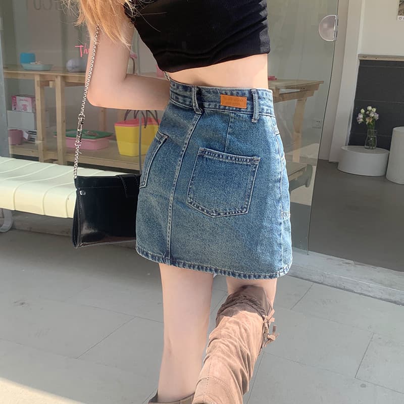 2025 estilo menina quente Retro Denim saia meio comprimento saia feminina primavera cintura alta mais magro olhar Hip-em
