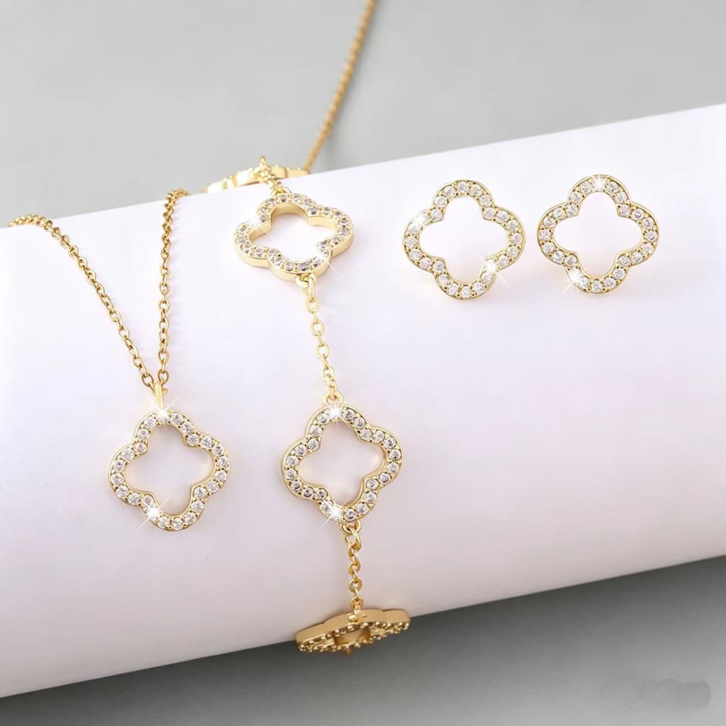 Novo conjunto de joias de três peças com zircônia microincrustada e design de flor de quatro folhas vazada