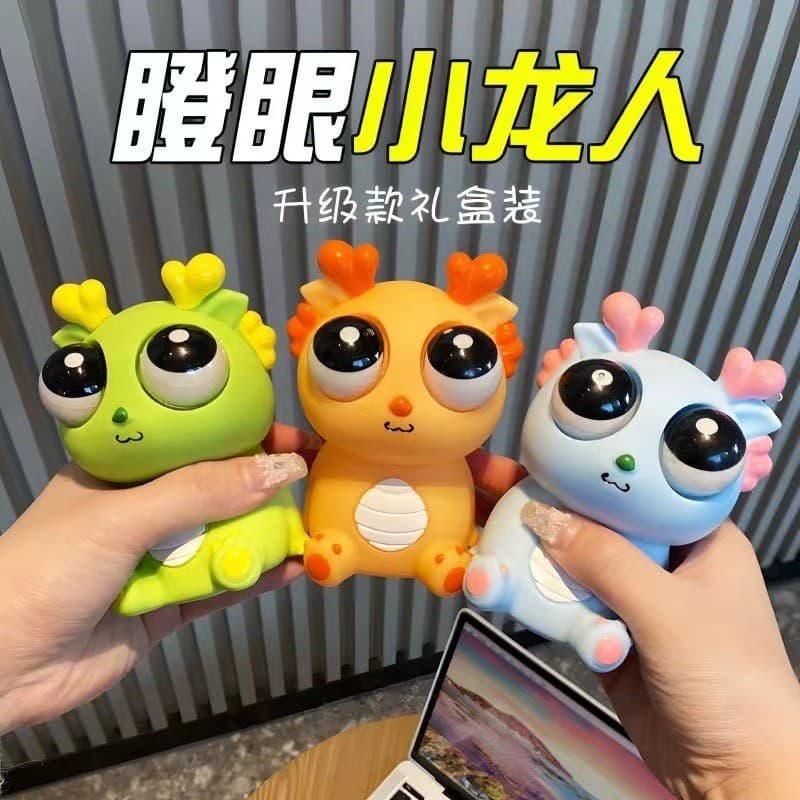 Brinquedo Pop-Eyed dragão pitada música criativo engraçado olhando dinossauro Squeeze ventilação venda quente descompres