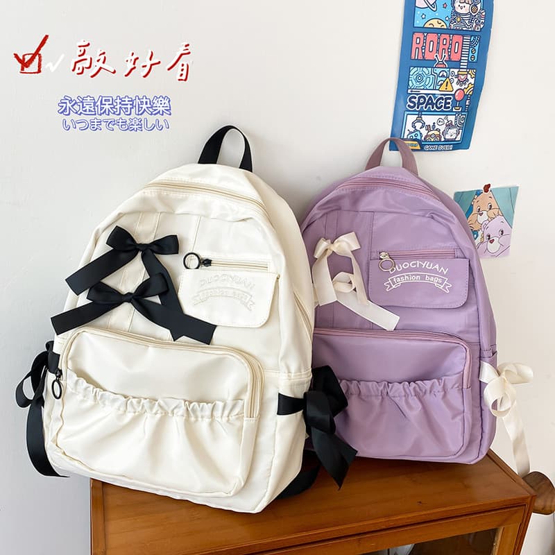 Animação japonesa periférica estilo Preppy bonito contraste cor arco plissado único macio menina estudante mochila femin