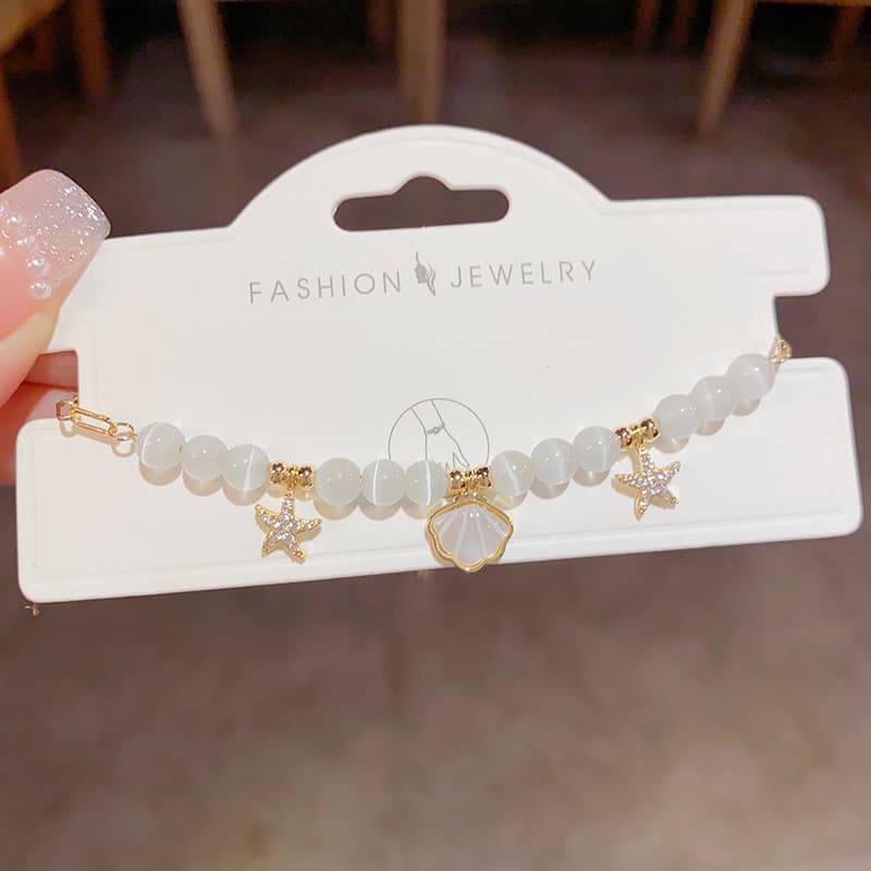 Nova moda de verão, pulseira elegante e moderna com conchas, estrelas-do-mar e pedras olho de gato, transparente, simple