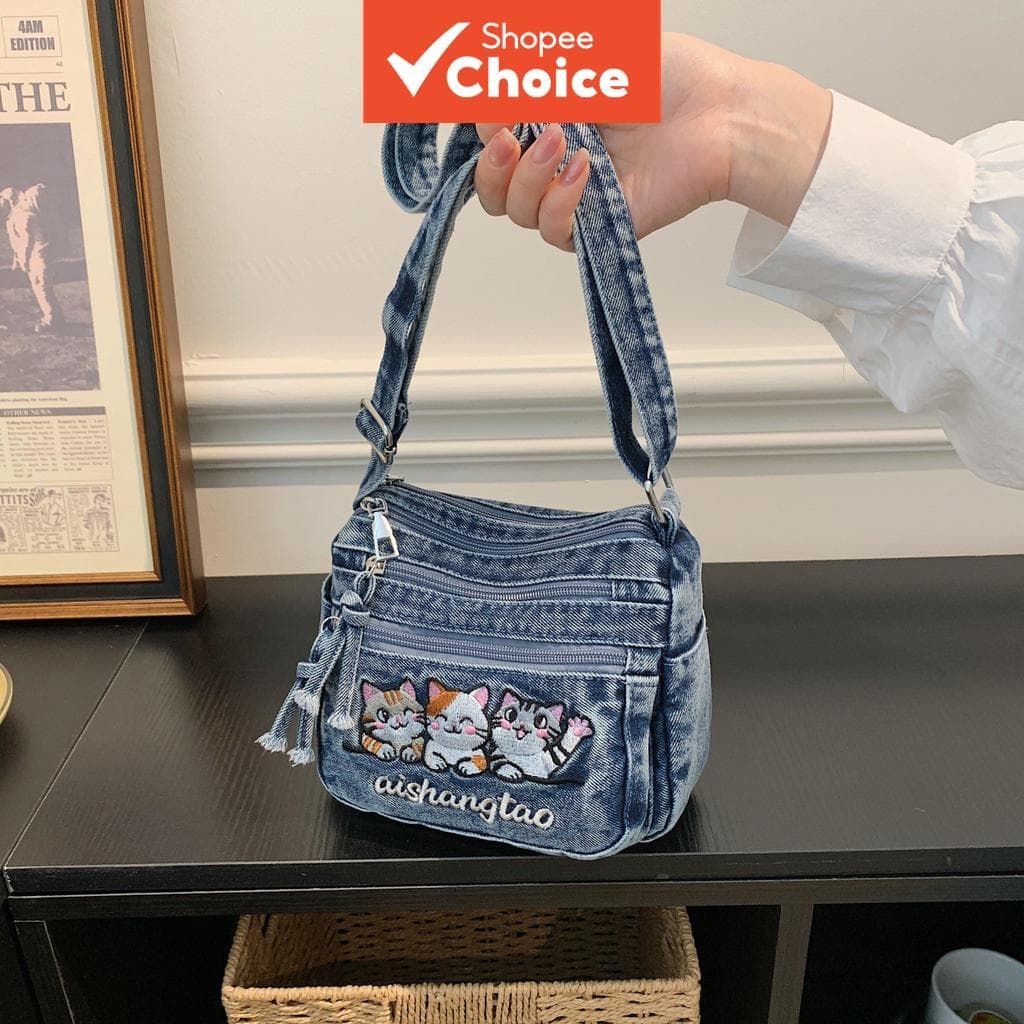 Bolsa tiracolo feminina casual de jeans azul com bordado de gatinho desenho animado adorável, franjas com zíperes de