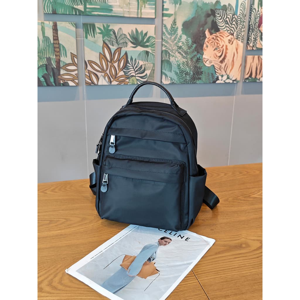 Mochila de viagem feminina 2026 novo estilo moda All-Match Commuter saco Oxford pano impermeável leve passeio pequena mo