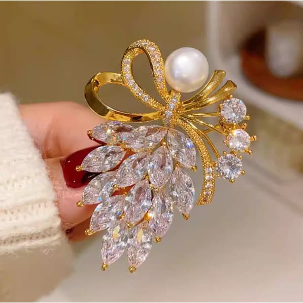 Broche em formato de buquê com laço para fixar acessórios de vestuário