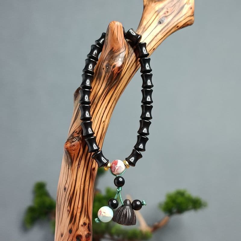 Pulseira de contas de bambu ébano para homens e mulheres, simbolizando progresso contínuo, com contas budistas de sândal