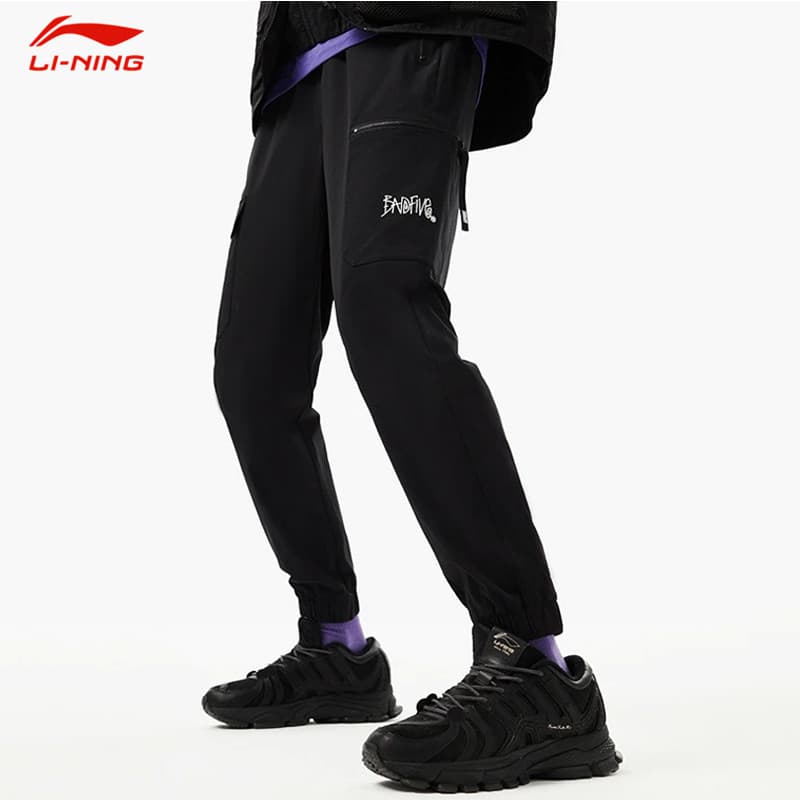 Li Ning Anti-Wu BADFIVE Calças Esportivas Calças Masculinas 2024 Primavera Verão Estilo Fino Solto Calças Esportivas Elá