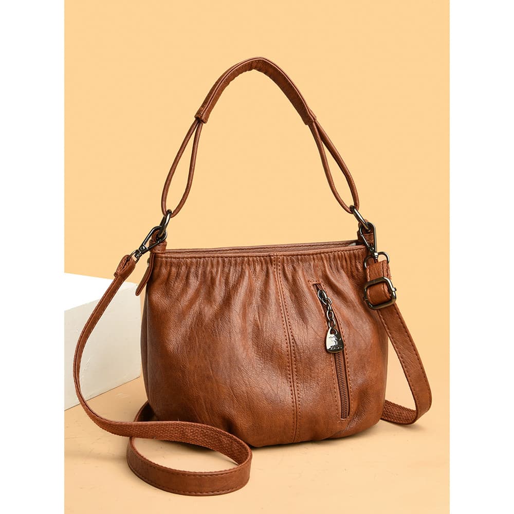 Bolsa feminina de couro genuíno 2025 novo estilo mãe de meia-idade couro macio grande capacidade bolsa balde atmosférica