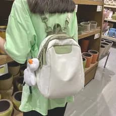 Ins japonês pequena mochila feminina 2026 novo estilo versão coreana Harajuku mochila de viagem simples cor sólida vaca