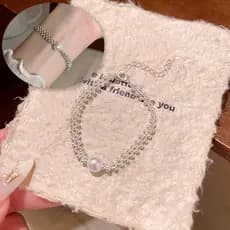 Pulseira de aço de titânio com pérolas artificiais, estilo francês, luxo discreto, simples e versátil.