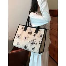 Nicho bolsa de lona feminina 2025 novo estilo portátil bolsa de ombro de grande capacidade estudante Casual All-Match Co