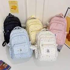 Mochila escolar para meninas do ensino fundamental, com um estilo jovial, design de laço com bolinhas, alto apelo estéti