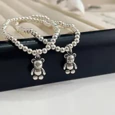 ✲Versão coreana S925 prata esterlina urso pulseira feminina simples All-Match bonito elástico redondo contas crianças pu