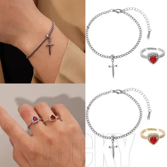 Um conjunto de anéis em forma de coração com strass vermelhos para casais - uma flecha perfurando o coração - pulseira G